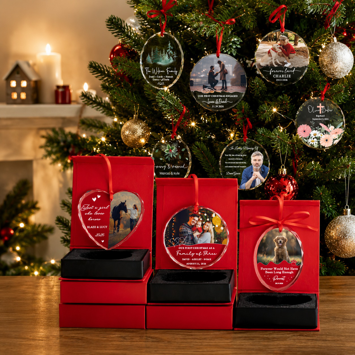 Personalized glass ornaments hanging on a Christmas tree and in red gift boxes