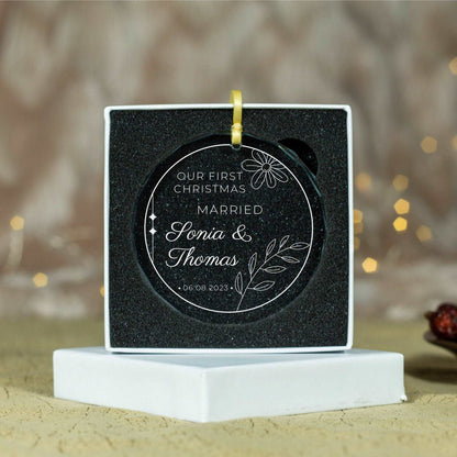 a black and white ornament with a gold ribbon