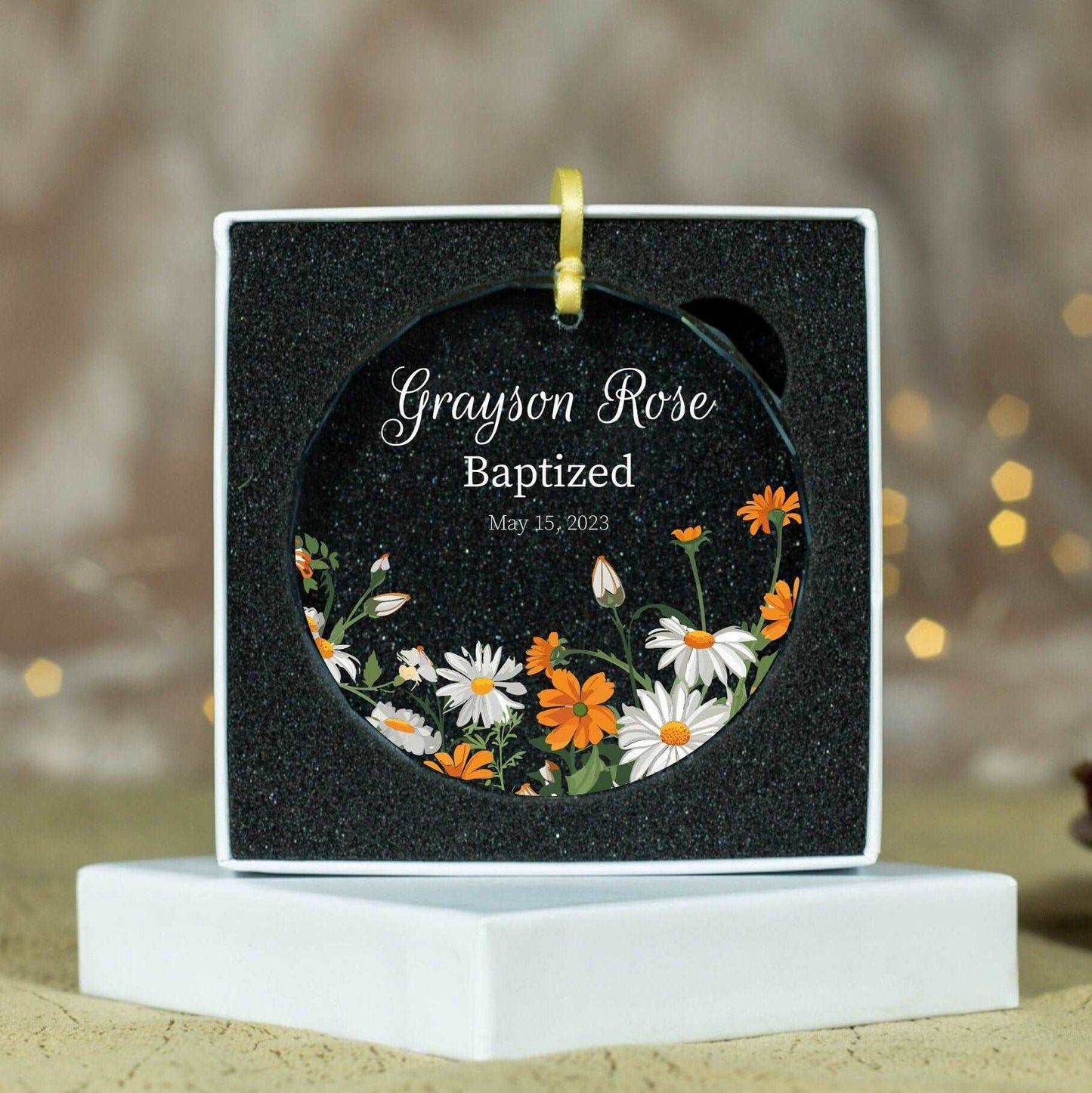 a personalized ornament with daisies and daisies on it