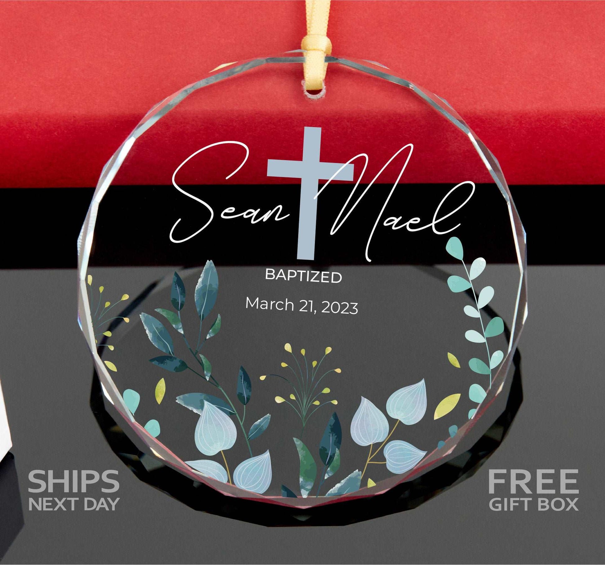 a glass ornament with a cross on it