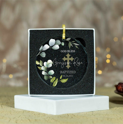 a small black box with a cross and flowers on it