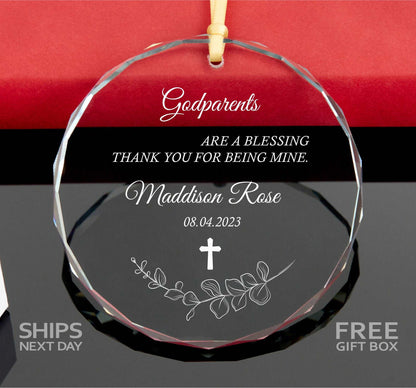 a glass ornament with a cross on it