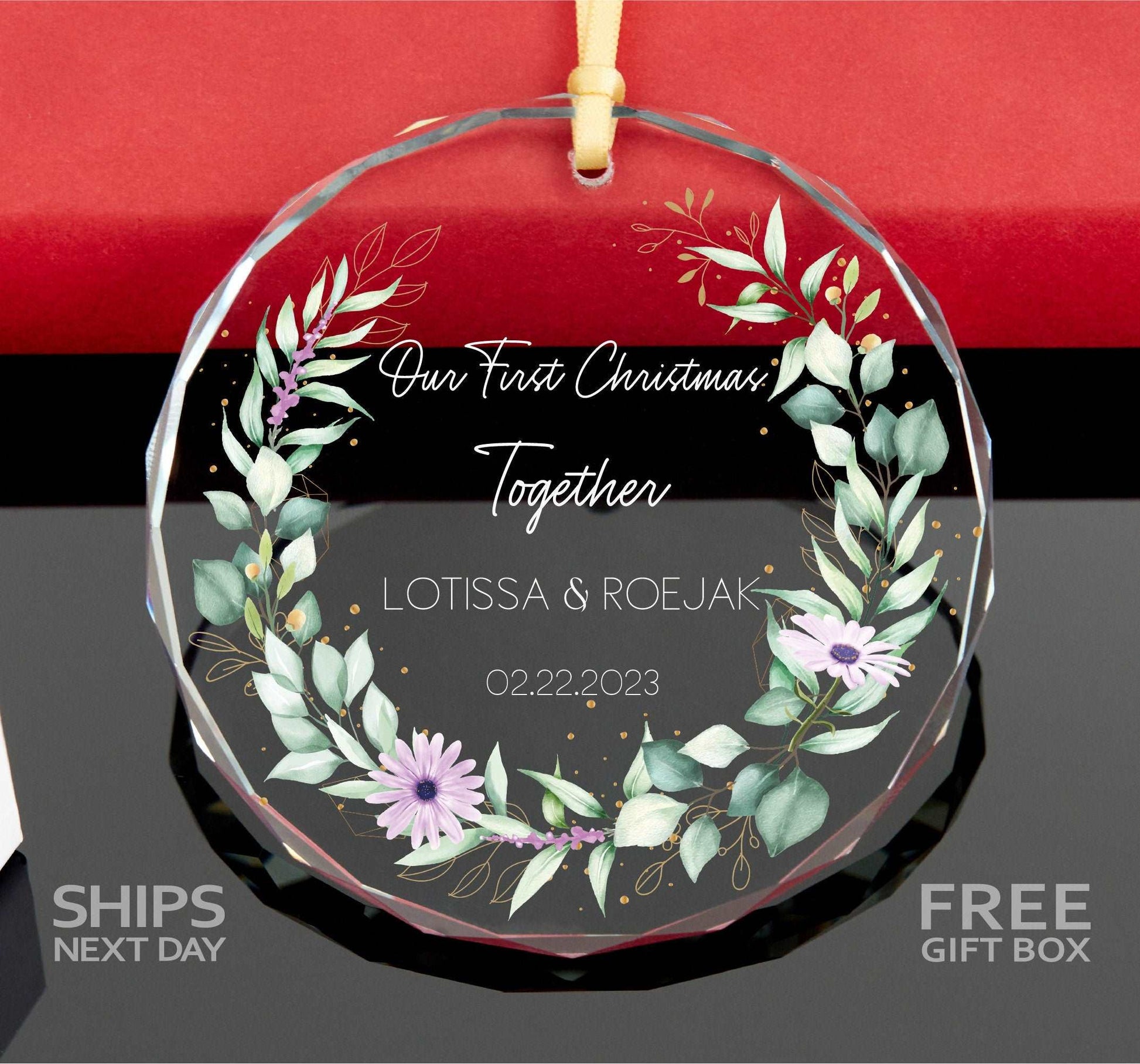 a glass ornament with a floral wreath on it