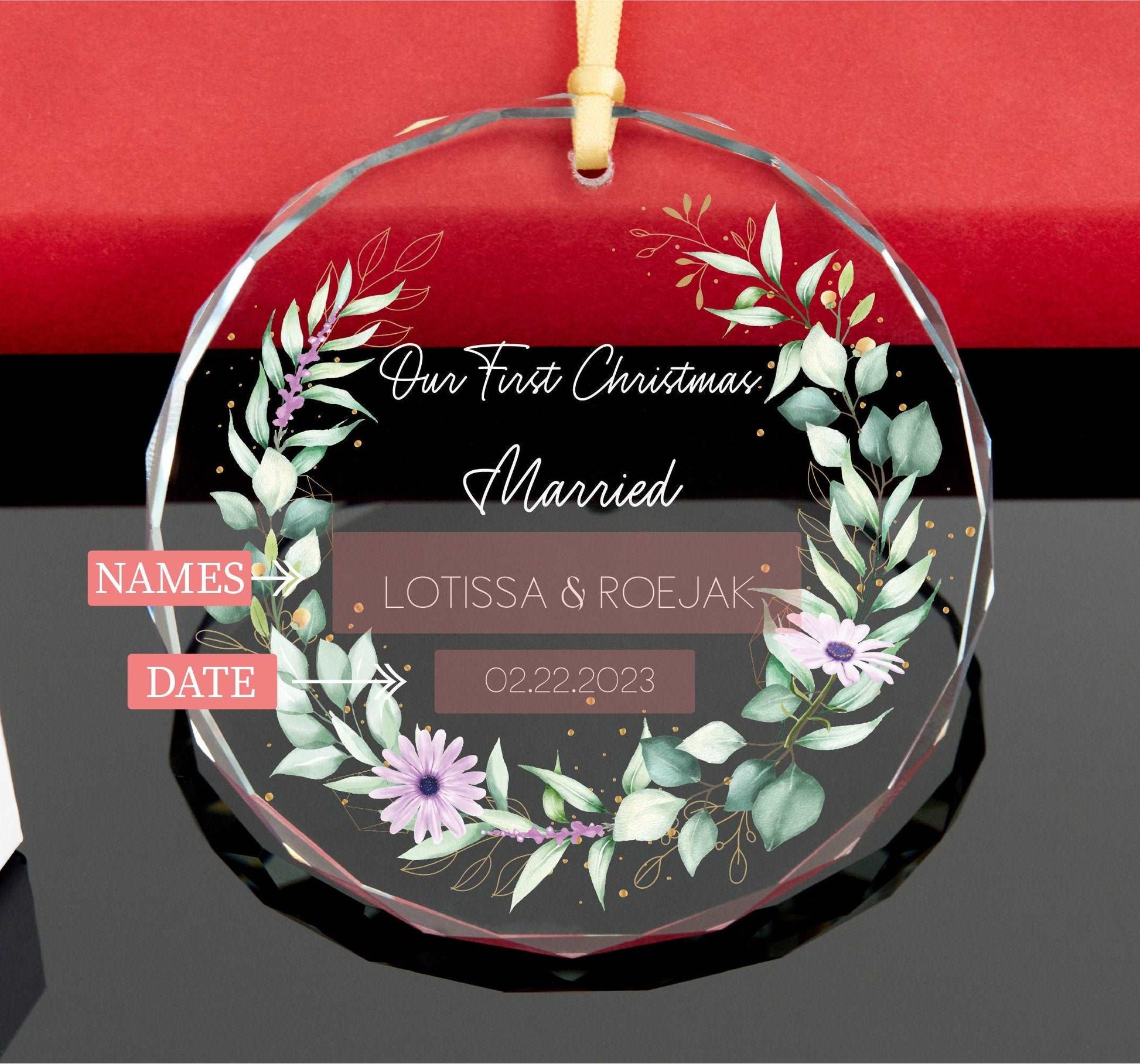 a glass ornament with a floral wreath on it