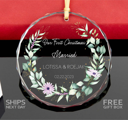 a glass ornament with a floral wreath on it