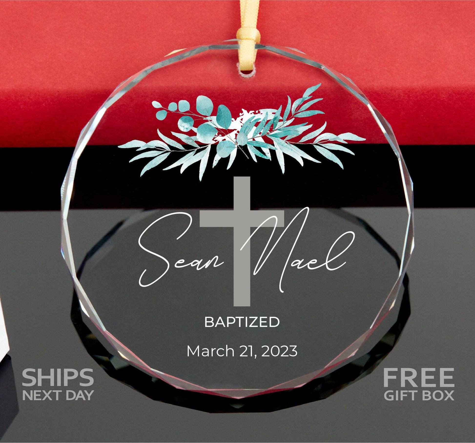 a glass ornament with a cross on it