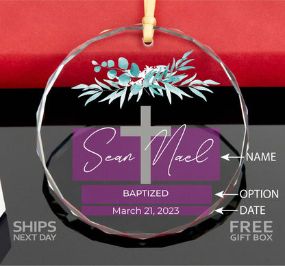 a glass ornament with a cross on it