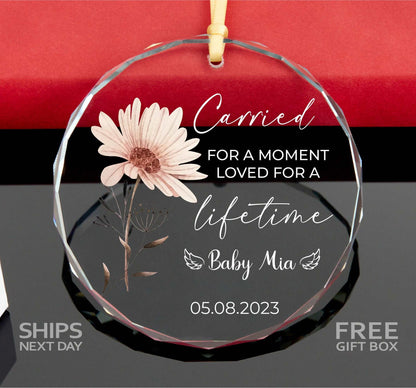 a glass ornament with a flower on it