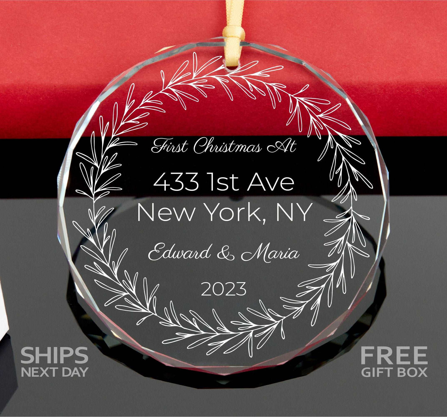 a glass ornament with a picture of a wreath on it