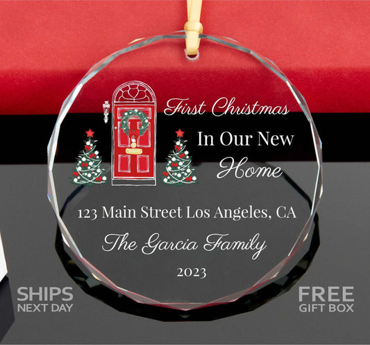 a glass ornament with a christmas tree and a red door