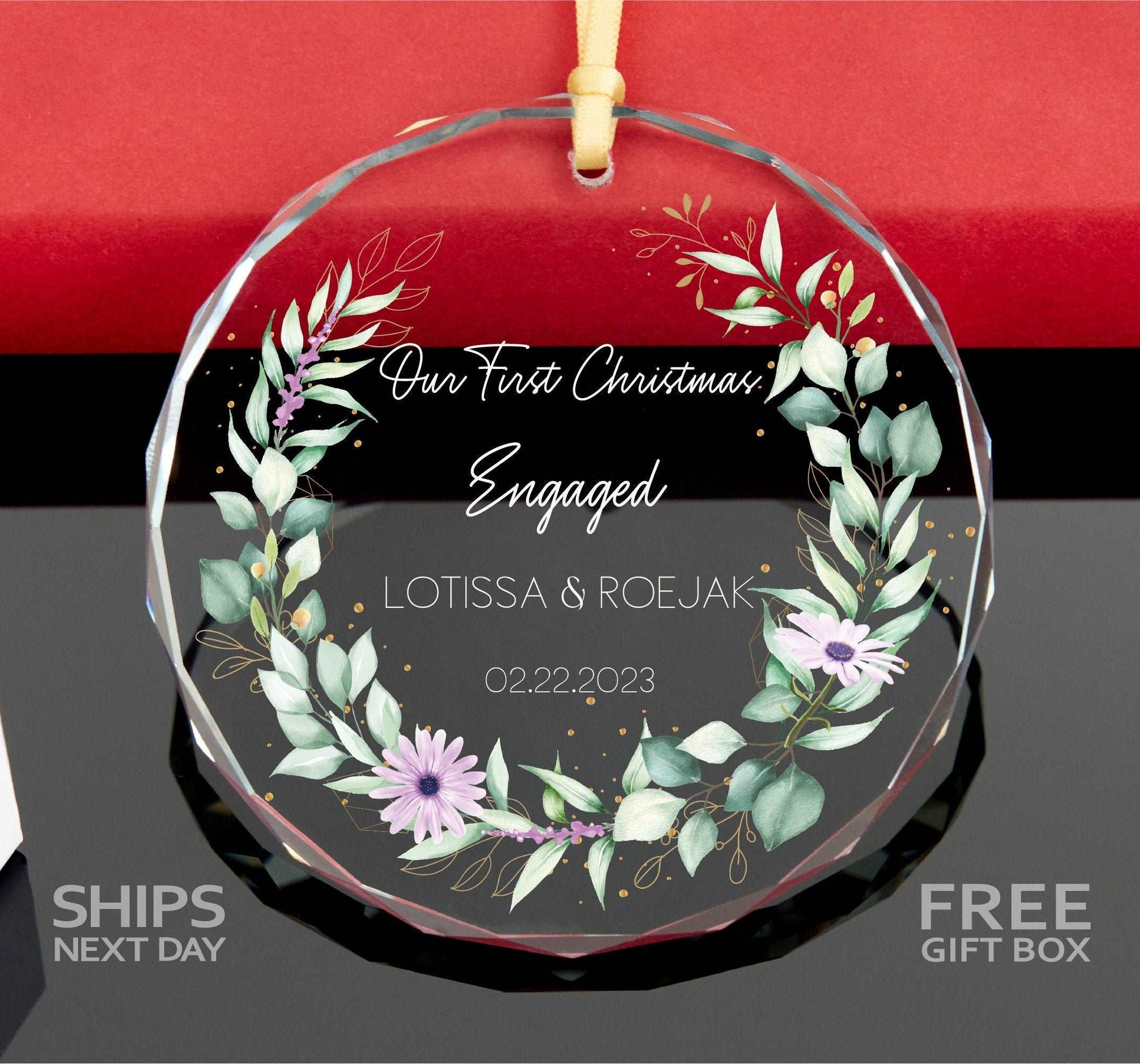 a glass ornament with a floral wreath on it