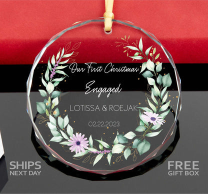 a glass ornament with a floral wreath on it