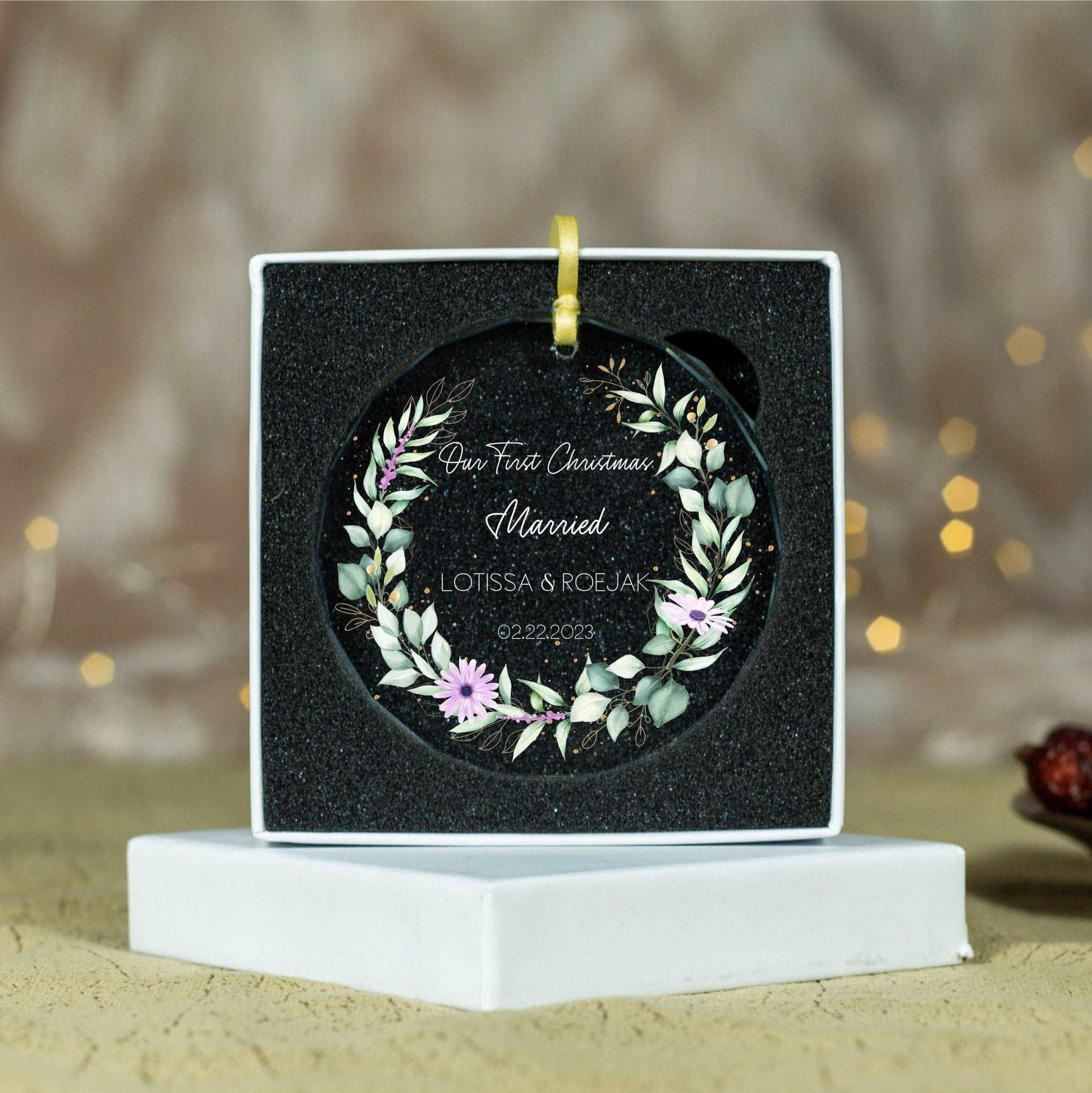 a black box with a floral wreath on it