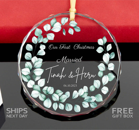 a glass ornament with a wreath on it