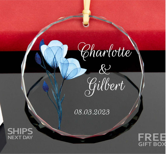 a glass ornament with a blue flower on it