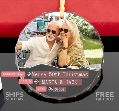 a glass ornament with a picture of a man and woman