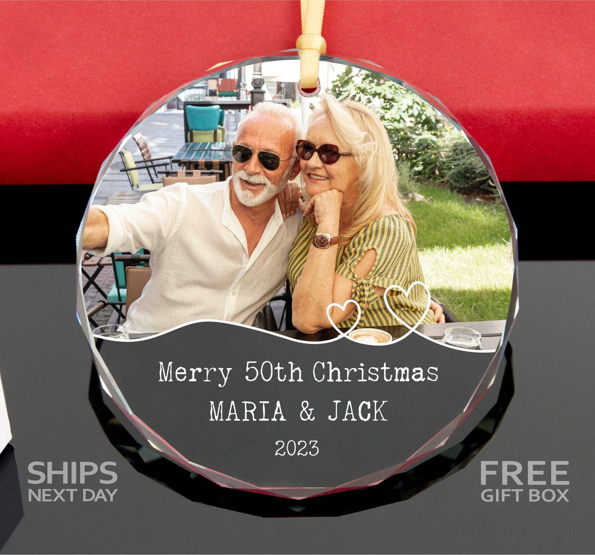 a glass ornament with a picture of a couple on it