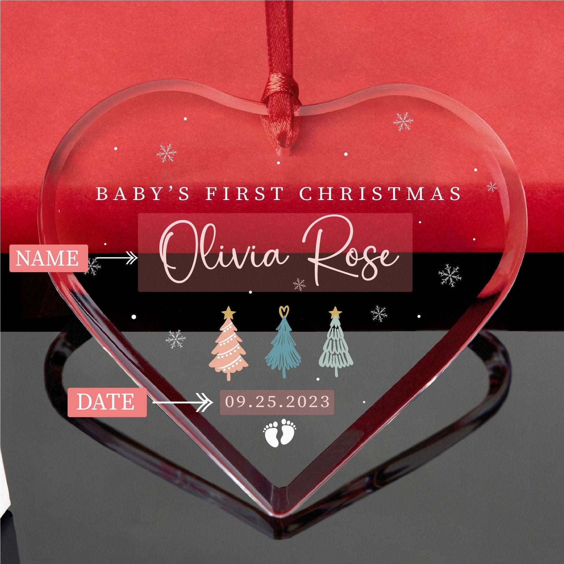 a baby's first christmas ornament hanging from a string