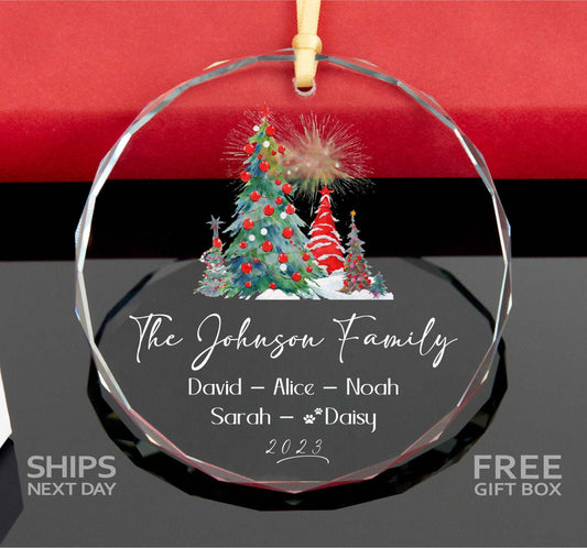 a glass ornament with a christmas tree on it