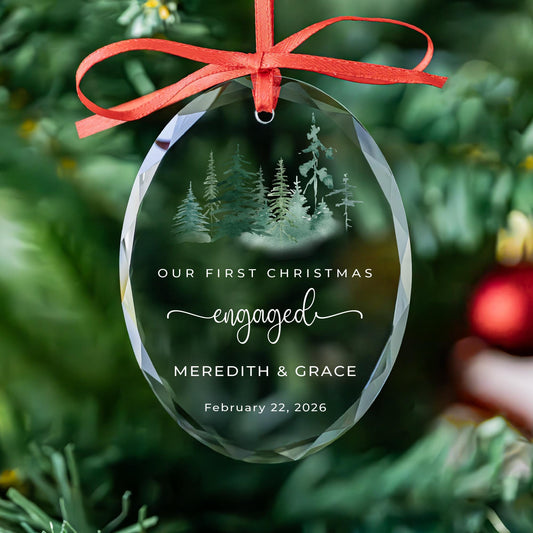 Personalized first Christmas engaged oval glass ornament with watercolor forest, names and date