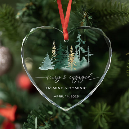 Personalized Merry and Engaged heart glass ornament with watercolor forest and gold accent pines, names and date