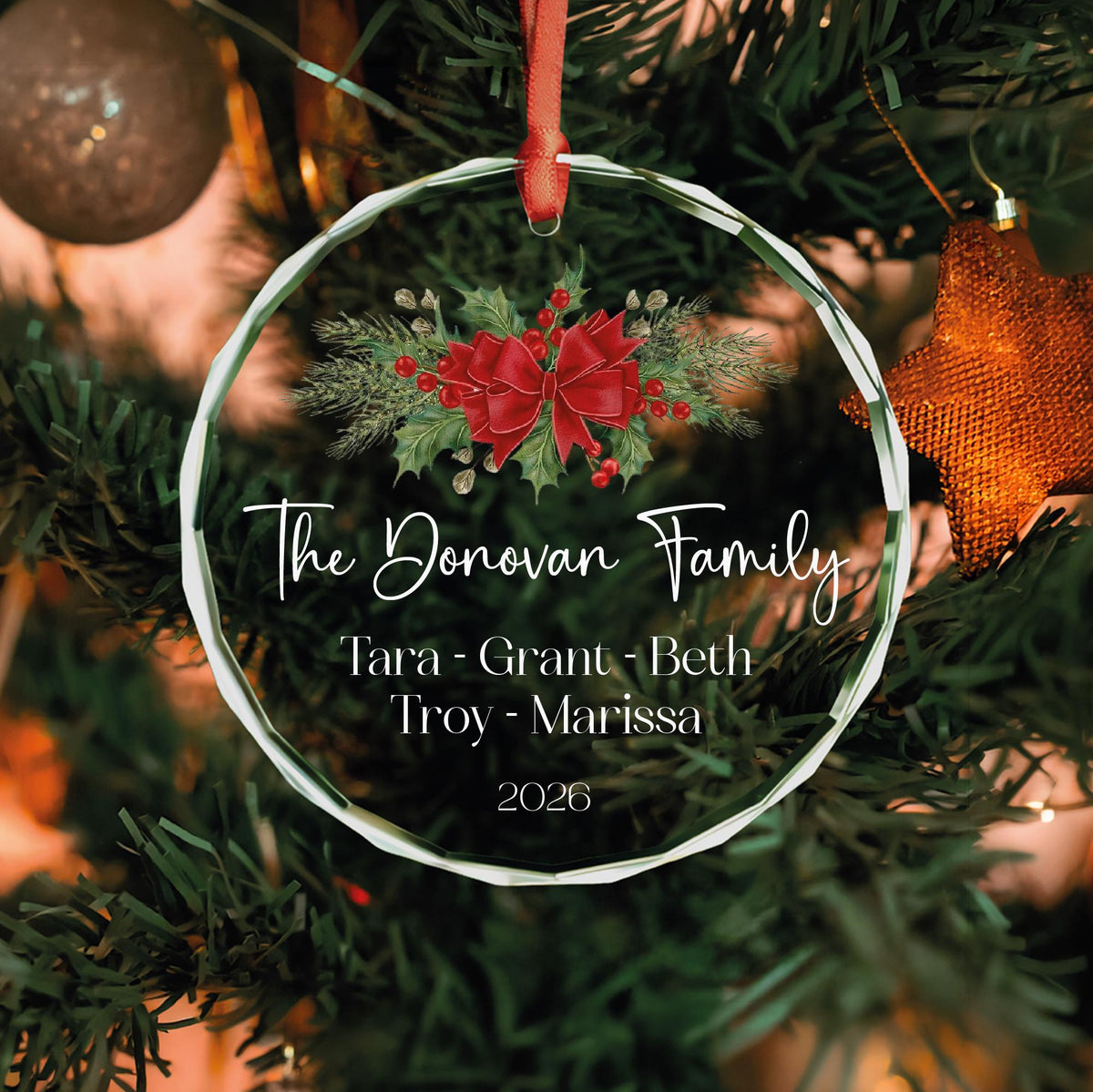 Personalized family glass ornament with red bow and holly, names and year