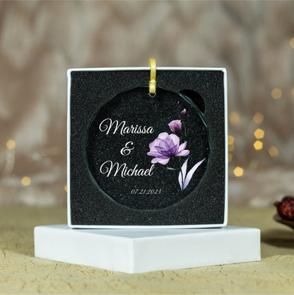 a wedding ornament with a purple flower on it