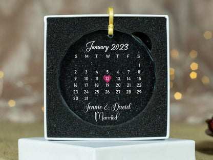 a personalized calendar ornament on a stand